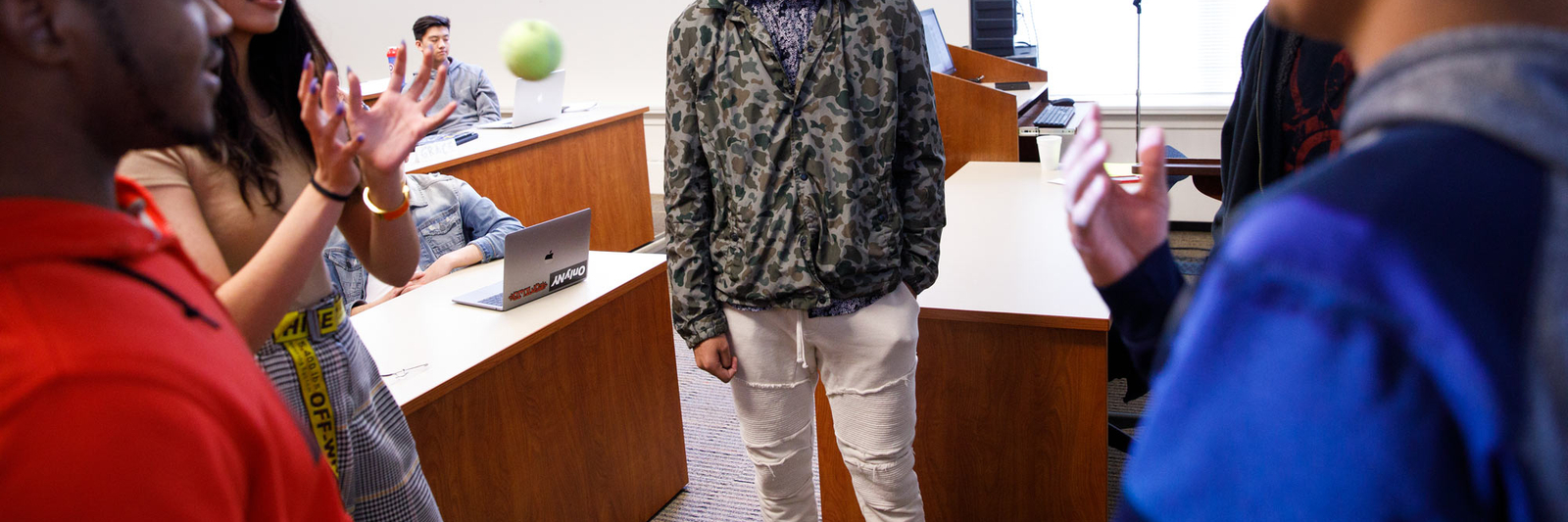 Students stand in a circle doing an interactive activity