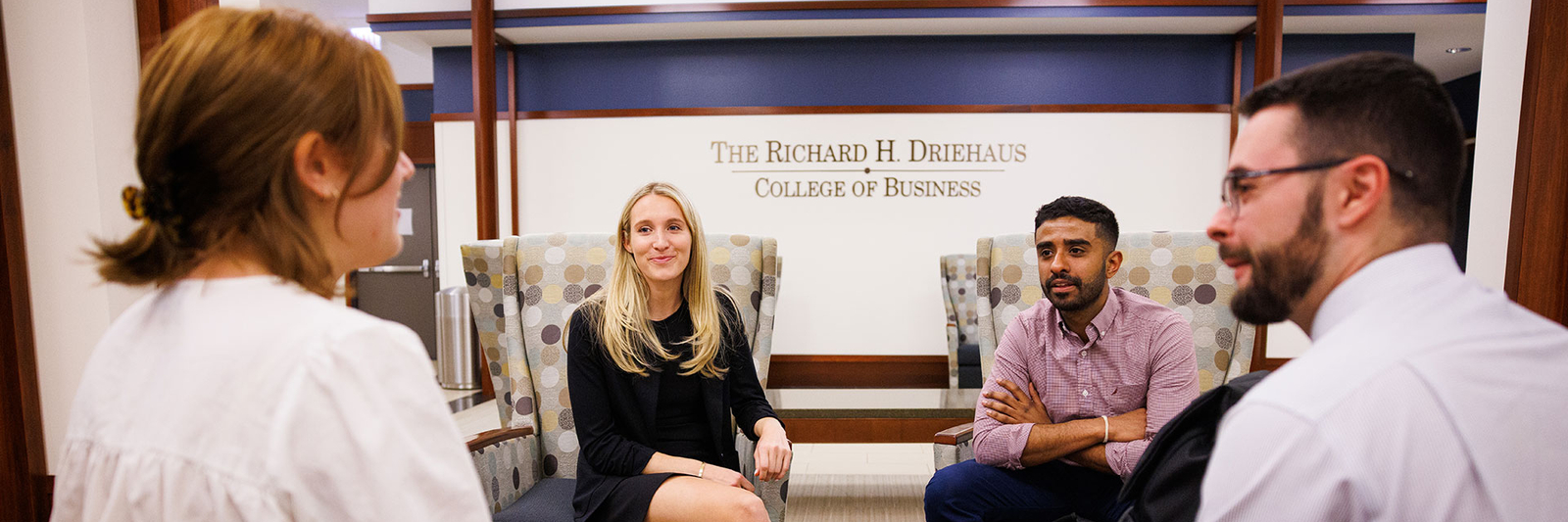 An image of students sitting down and talking to each other