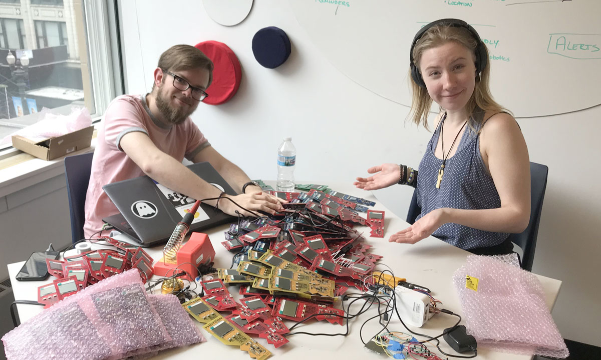 two students with a lot of parts on table