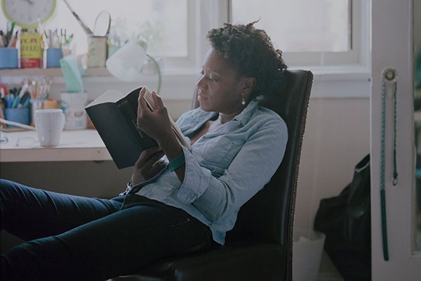 Woman seated and reading a book