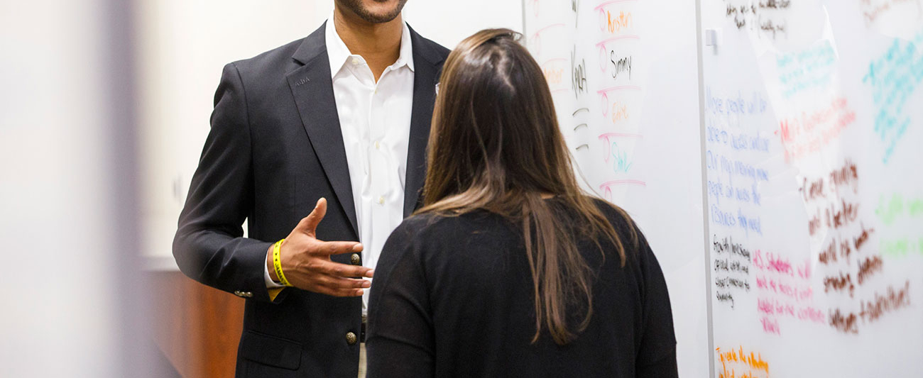 Student writing on whiteboard