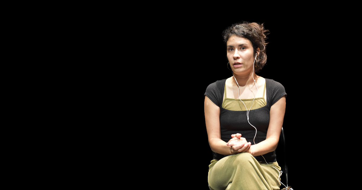 A woman with headphones performing